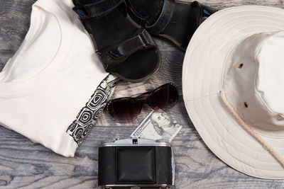 High angle view of person holding camera on table