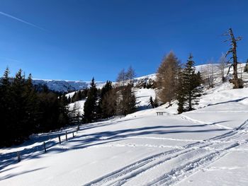 Scenic view of snowcapped mountains against clear blue sky