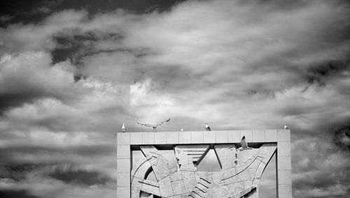 Low angle view of building against cloudy sky