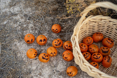 Healthy trick or treat snacks for kids on halloween--basket of mandarin oranges jack o lantern faces