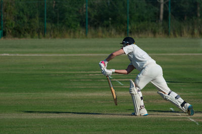 Man playing cricket in stadium