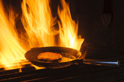 Cooking food in pan in charcoal kiln, hunneberg, sweden, europe