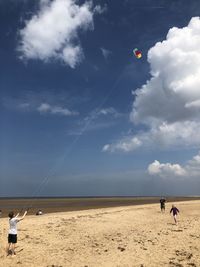 Flying kite on sandy beach norfolk 