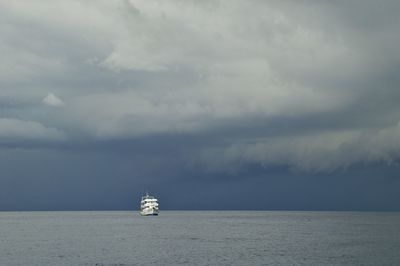 Sailboat sailing on sea against sky