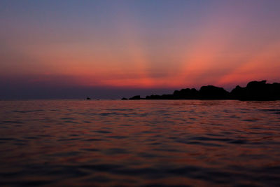 Scenic view of sea against romantic sky at sunset