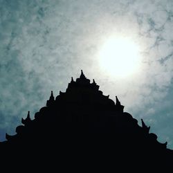 Low angle view of silhouette temple against sky