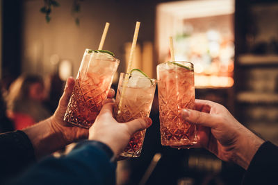 Cropped hands of people holding drinks