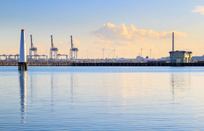 View of factory at commercial dock against sky