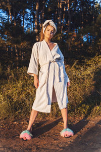 Portrait of woman standing in forest