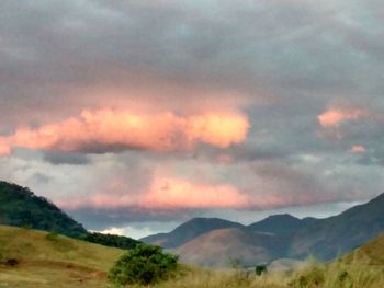 Scenic view of mountains against cloudy sky