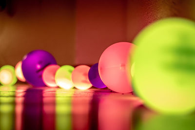 Close-up of multi colored illuminated balls on floor