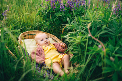 Portrait of young woman sitting on grass