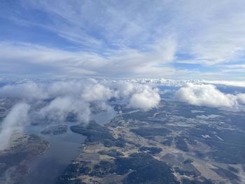 Aerial view of clouds over landscape against sky