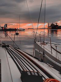 View of boats in sea against cloudy sky