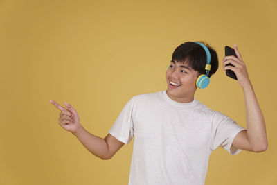 Portrait of smiling young man using mobile phone