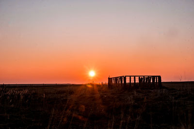 Scenic view of field against sky during sunset