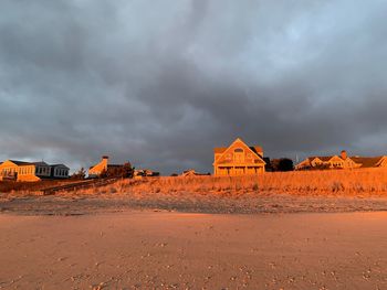 Built structure on land against cloudy sky