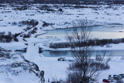 High angle view of snow covered trees by lake