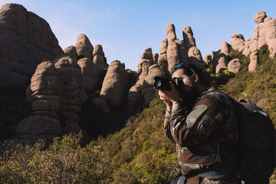 Rear view of man standing on rock