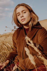 Portrait of a young woman in a field