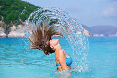 Full length of young woman in sea