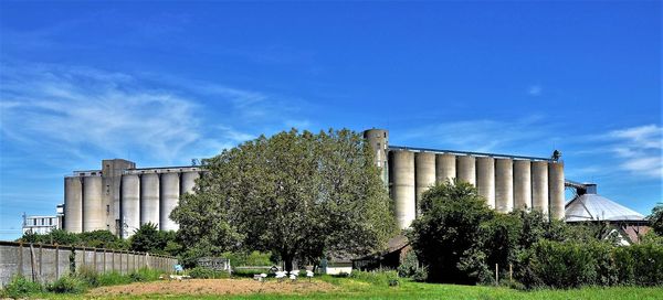 View of factory against blue sky