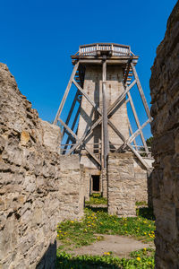 Low angle view of old building against clear blue sky