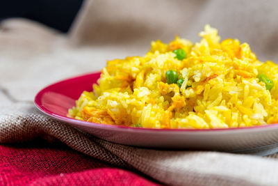 Close-up of fried rice in plate on jute