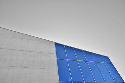 Low angle view of modern building against clear blue sky