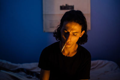Close-up of young woman on bed at home