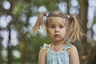 Portrait of young woman standing outdoors