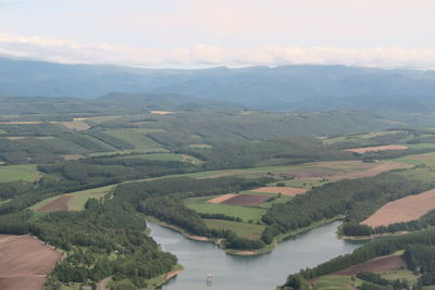 High angle view of river amidst landscape against sky