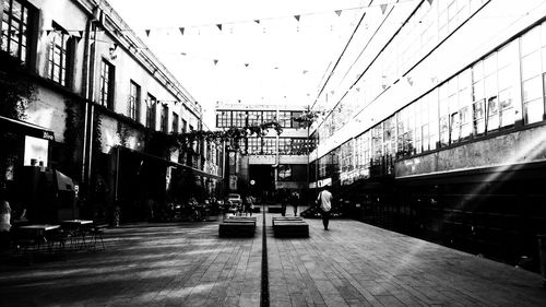 Cars on city street against sky