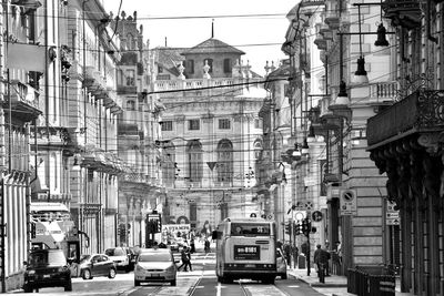 Cars on street amidst buildings in city