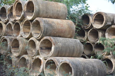 Stack of pipes on field