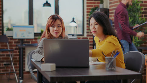 Smiling business colleagues working in office