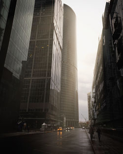 Street amidst buildings against sky in city