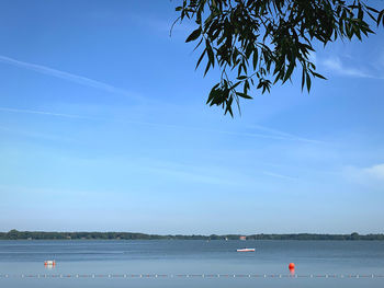 Scenic view of sea against blue sky