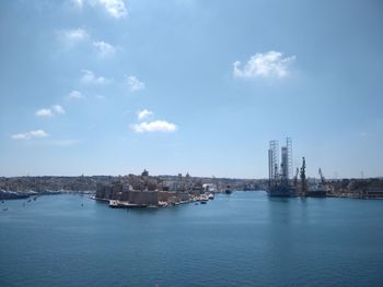 View of city buildings against cloudy sky