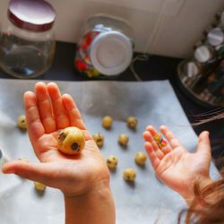 Cropped image of girl making cookies in kitchen