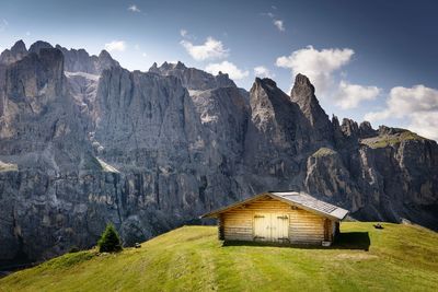 House on mountain against sky