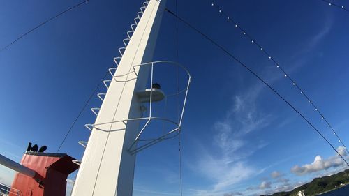 Low angle view of cables against blue sky