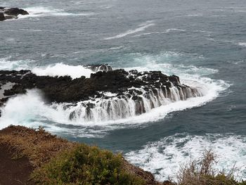 High angle view of waves breaking on beach