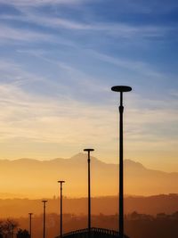 Low angle view of street light against sky during sunset