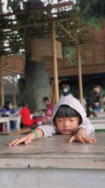 Portrait of young woman sitting at park