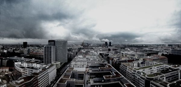 Cityscape against cloudy sky