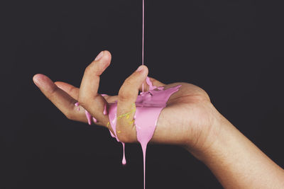 Close-up of hands over black background