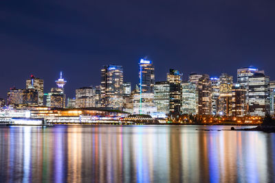 Illuminated buildings against sky at night