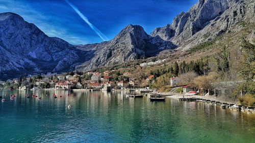 Scenic view of lake and mountains against blue sky