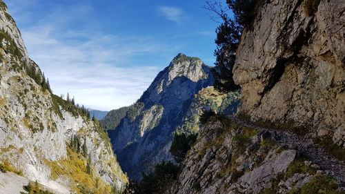 Low angle view of rocky mountains against sky